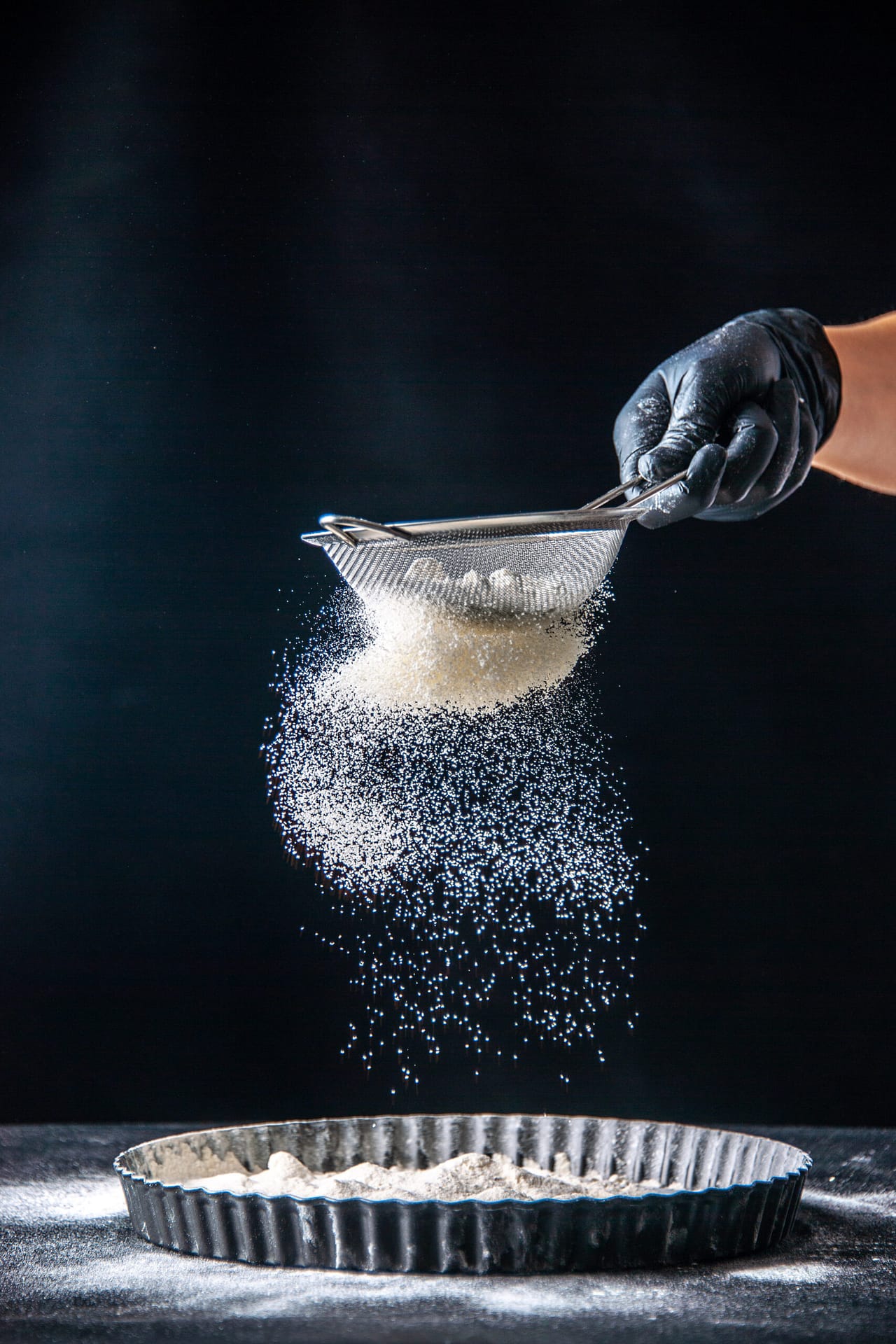front view female cook pouring white flour into the pan on the dark background dough egg job bakery hotcake pastry kitchen cuisine